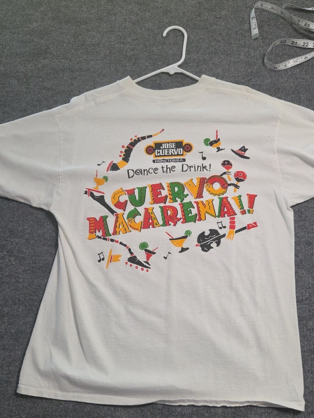 Delta White Tee with Colorful 'Cuervo Macarena' Graphic